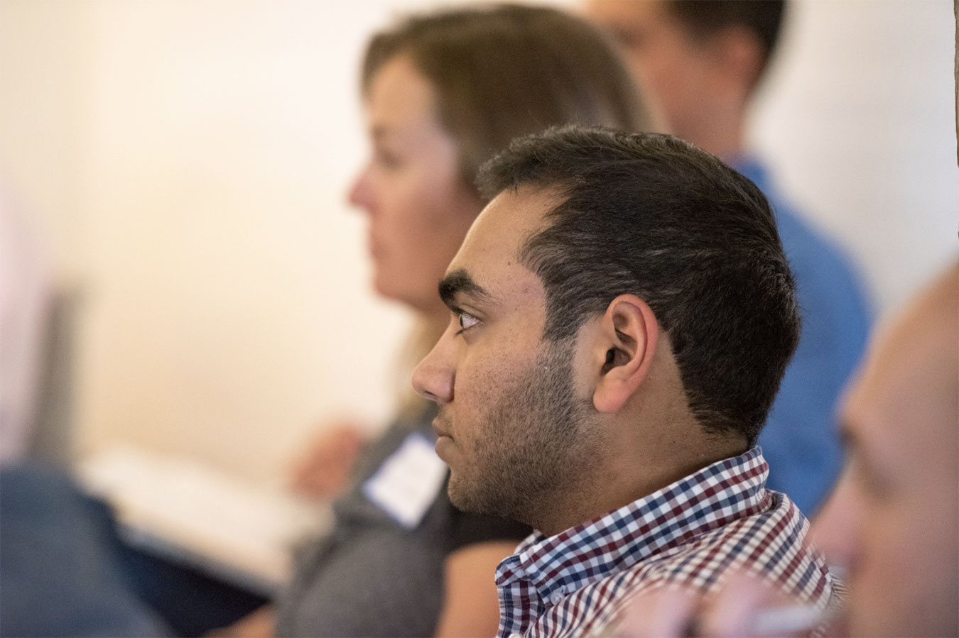 People sitting and listening attentively to a speaker